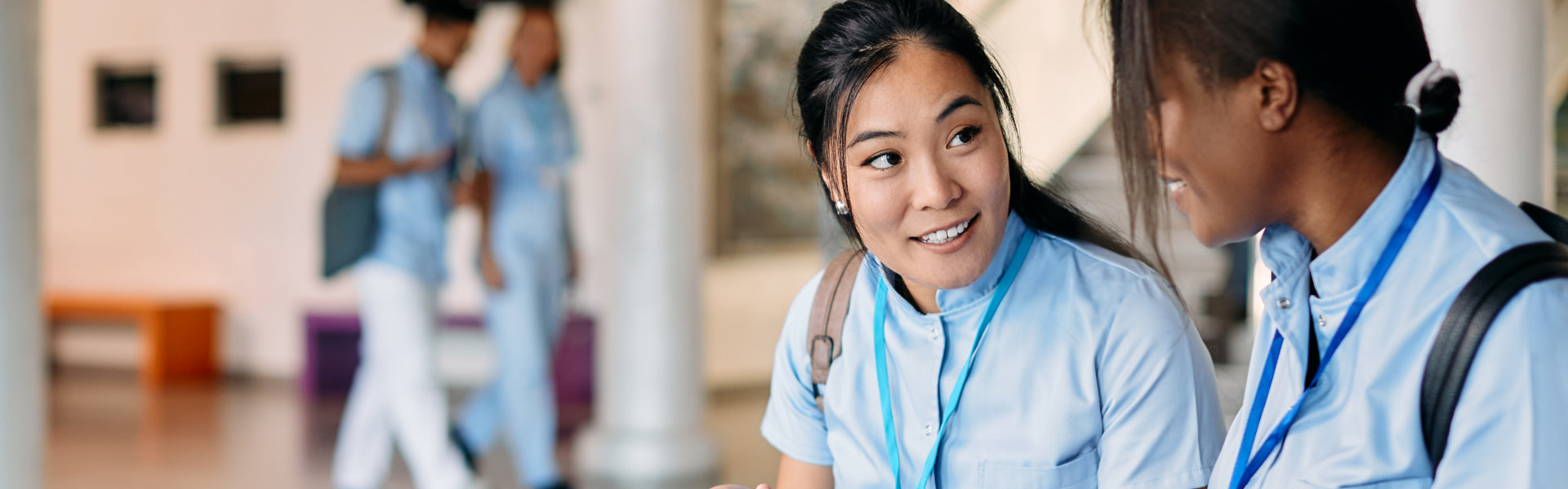 medical students communicating while learning at university hallway
